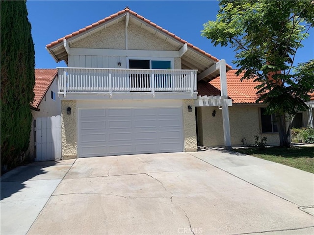 8818 Keremeos Way, San Diego, CA 92126 - view of front of house with a balcony, a tile roof, and driveway