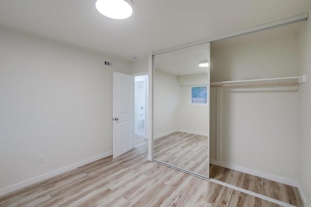 6548 Bantam Lake Cir, San Diego, CA 92119 - unfurnished bedroom featuring a closet, wood finished floors, and baseboards