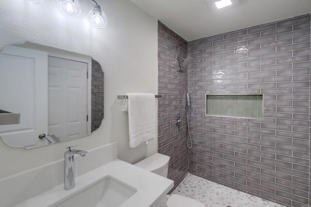 6548 Bantam Lake Cir, San Diego, CA 92119 - bathroom featuring tiled shower, toilet, and vanity