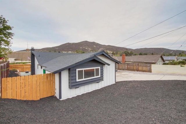 6548 Bantam Lake Cir, San Diego, CA 92119 - view of property exterior featuring a mountain view, fence, board and batten siding, and a patio