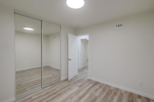 6548 Bantam Lake Cir, San Diego, CA 92119 - unfurnished bedroom featuring wood finished floors, a closet, and baseboards