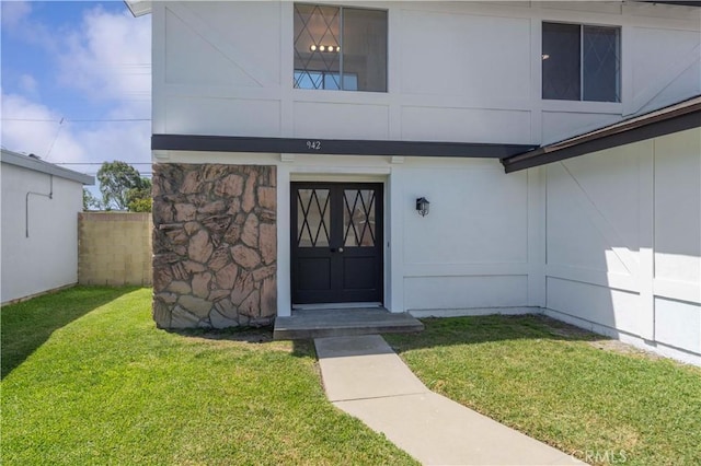 942 E Denwall Dr, Carson, CA 90746 - doorway to property with a lawn and stone siding