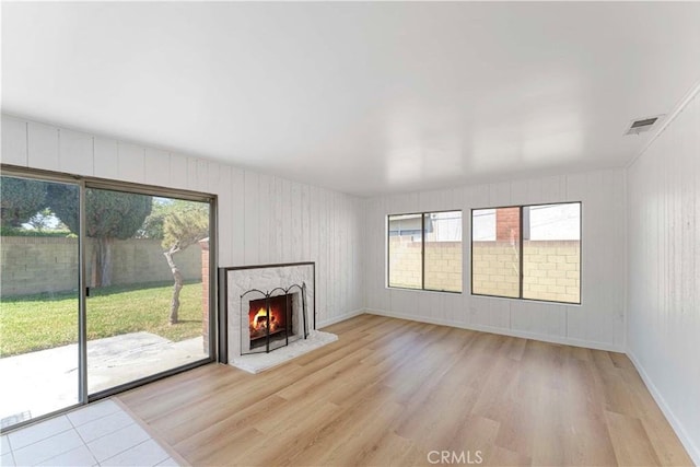 942 E Denwall Dr, Carson, CA 90746 - unfurnished living room with light wood-style floors and a lit fireplace