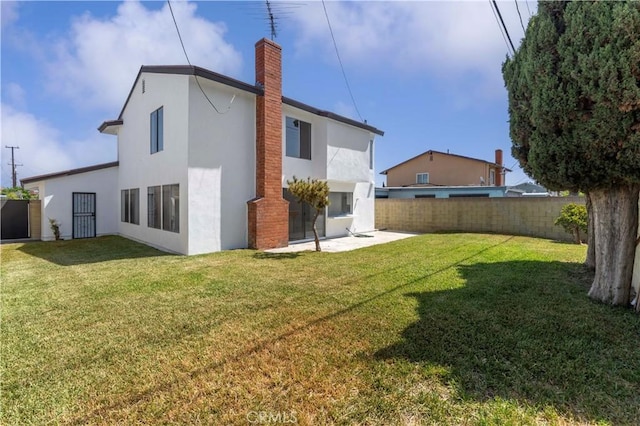 942 E Denwall Dr, Carson, CA 90746 - rear view of property featuring stucco siding, a chimney, and a patio