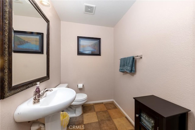 6122 Glen Abbey Pl, Fontana, CA 92336 - half bathroom with baseboards, toilet, and a sink