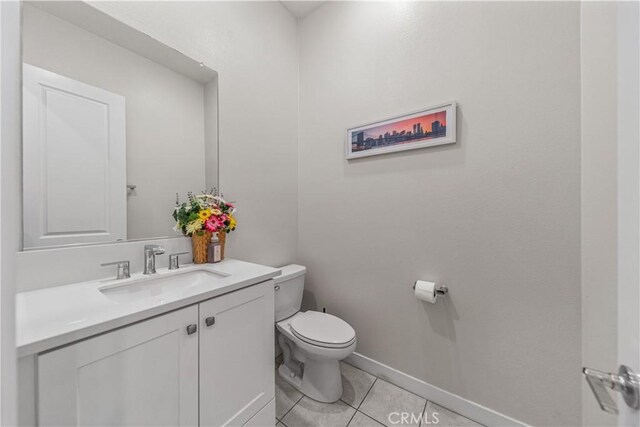27218 Narrowleaf Willow Ln, Valencia, CA 91381 - half bath featuring toilet, tile patterned floors, baseboards, and vanity
