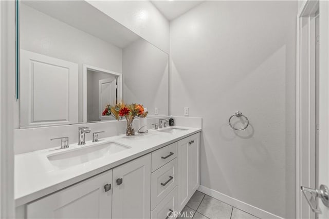 27218 Narrowleaf Willow Ln, Valencia, CA 91381 - bathroom with tile patterned flooring, double vanity, and baseboards