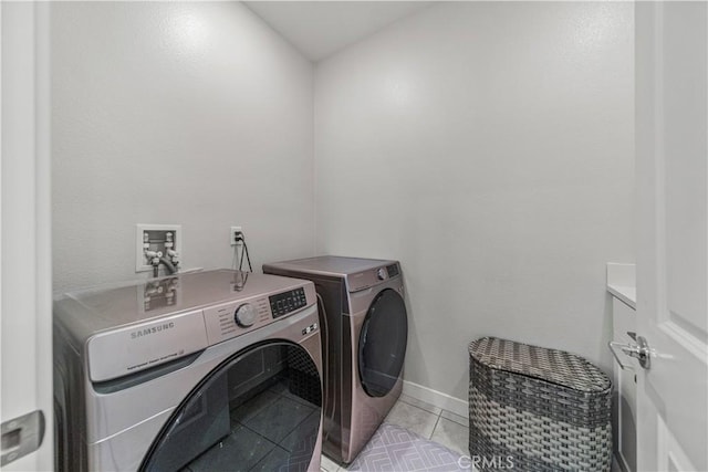 27218 Narrowleaf Willow Ln, Valencia, CA 91381 - laundry room with separate washer and dryer, light tile patterned flooring, and baseboards