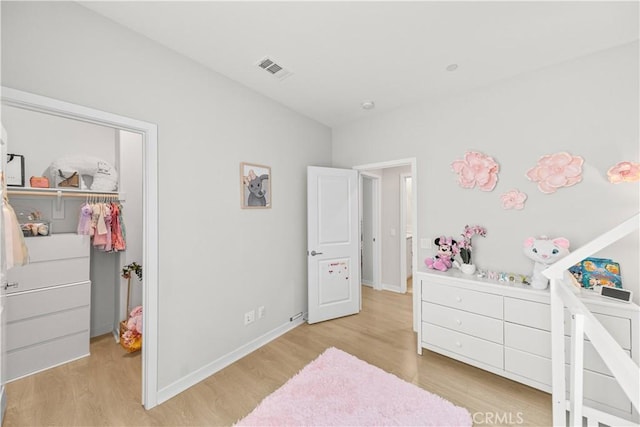 27218 Narrowleaf Willow Ln, Valencia, CA 91381 - bedroom featuring light wood-style floors, baseboards, a closet, and a spacious closet