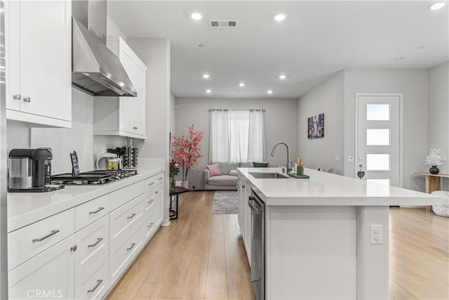 27218 Narrowleaf Willow Ln, Valencia, CA 91381 - kitchen featuring wall chimney range hood, a sink, appliances with stainless steel finishes, healthy amount of natural light, and recessed lighting