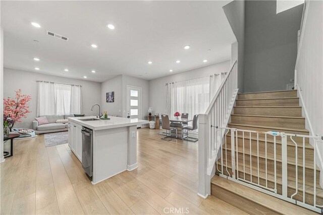 27218 Narrowleaf Willow Ln, Valencia, CA 91381 - kitchen featuring open floor plan, a sink, a kitchen island with sink, recessed lighting, and light wood-style flooring