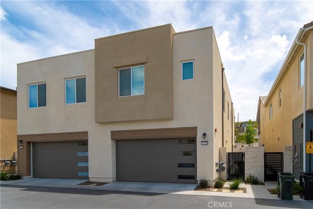 27218 Narrowleaf Willow Ln, Valencia, CA 91381 - view of front facade with stucco siding and a garage