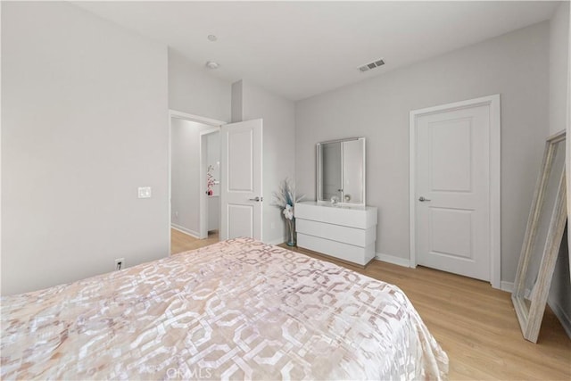 27218 Narrowleaf Willow Ln, Valencia, CA 91381 - bedroom with light wood-type flooring and baseboards