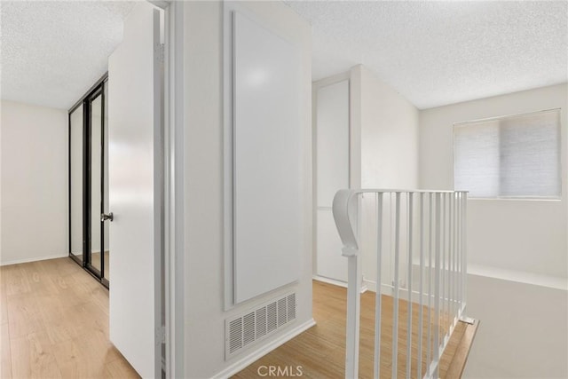 16925 Kemerton Pl, Hacienda Heights, CA 91745 - hallway with a textured ceiling, wood finished floors, and an upstairs landing