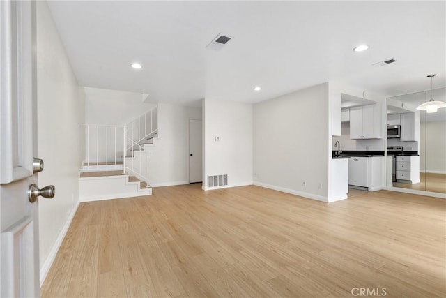 16925 Kemerton Pl, Hacienda Heights, CA 91745 - unfurnished living room featuring light wood-type flooring, baseboards, stairs, and recessed lighting