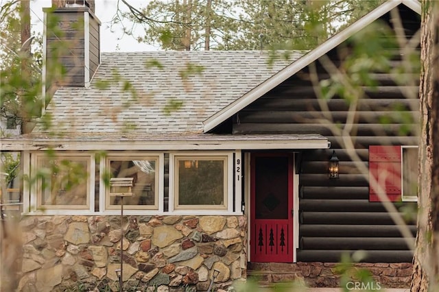 921 Anita Ave, Big Bear City, CA 92314 - entrance to property with a shingled roof, a chimney, and stone siding
