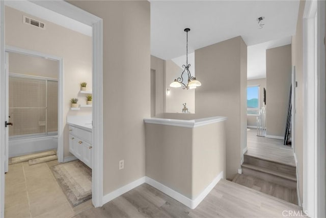 27055 Big Horn Mountain Way, Yorba Linda, CA 92887 - hallway with a chandelier, an upstairs landing, baseboards, and light wood-style flooring