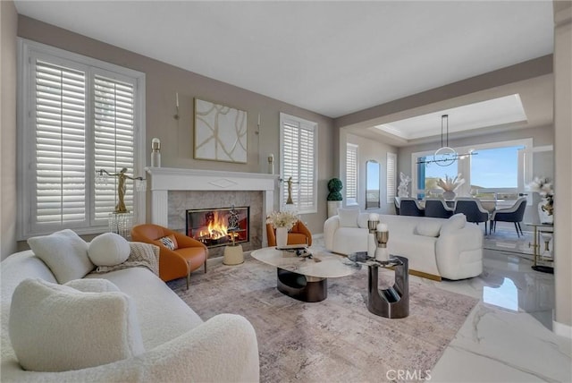 27055 Big Horn Mountain Way, Yorba Linda, CA 92887 - living area with marble tiled floors, a fireplace, a chandelier, and a raised ceiling
