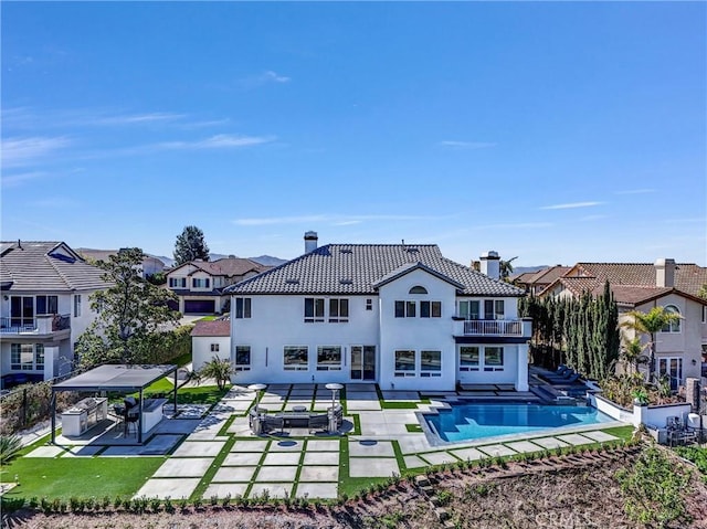 27055 Big Horn Mountain Way, Yorba Linda, CA 92887 - rear view of property featuring a balcony, a chimney, a gazebo, a patio, and an outdoor pool