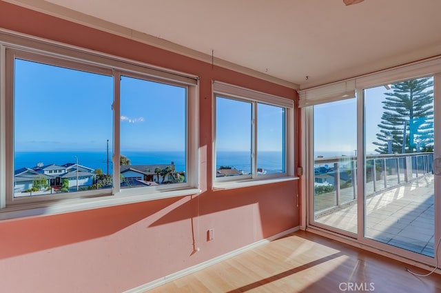 1947 Palacios Dr, San Pedro, CA 90732 - unfurnished sunroom featuring a water view, wood finished floors, baseboards, and healthy amount of natural light