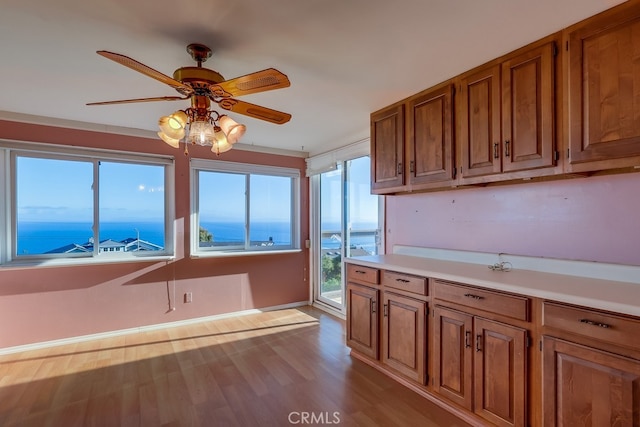 1947 Palacios Dr, San Pedro, CA 90732 - kitchen featuring brown cabinets, light countertops, wood finished floors, a ceiling fan, and baseboards