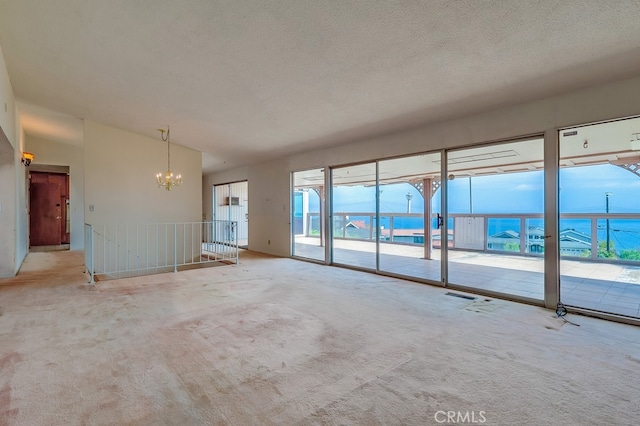1947 Palacios Dr, San Pedro, CA 90732 - unfurnished living room featuring a chandelier, carpet, and a textured ceiling
