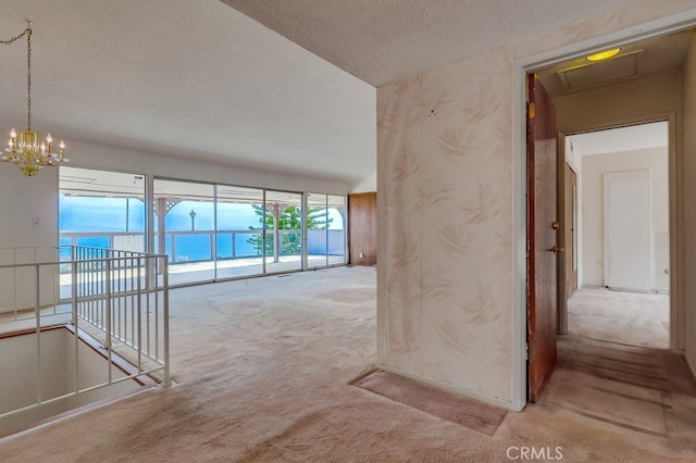 1947 Palacios Dr, San Pedro, CA 90732 - hallway with carpet floors, a chandelier, an upstairs landing, and a textured ceiling