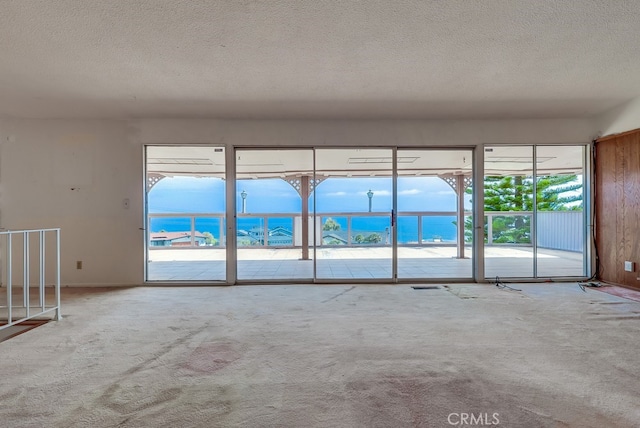 1947 Palacios Dr, San Pedro, CA 90732 - carpeted empty room with a textured ceiling, plenty of natural light, and a water view