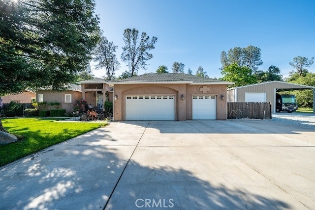 ranch-style house with a front lawn, concrete driveway, a garage, and stucco siding