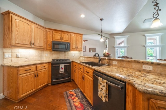 kitchen featuring black appliances, a sink, light stone counters, tasteful backsplash, and recessed lighting