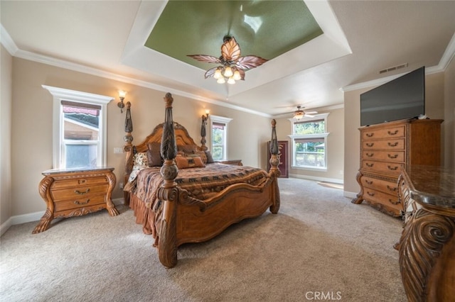 bedroom featuring carpet flooring, ornamental molding, ceiling fan, a tray ceiling, and baseboards