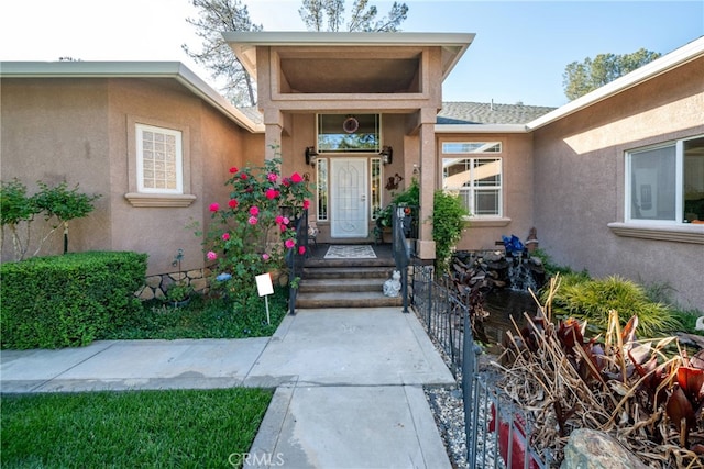property entrance with stucco siding