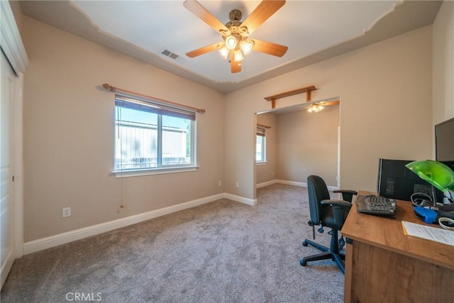 office space with carpet floors, a ceiling fan, and baseboards