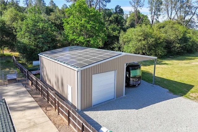 garage featuring a detached garage and view of scattered trees