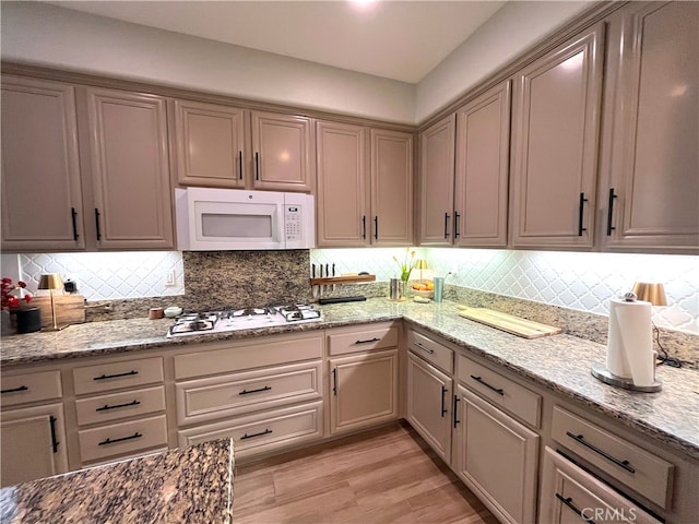 45723 Pheasant Pl, Temecula, CA 92592 - kitchen with white appliances, decorative backsplash, light wood-style flooring, and light stone countertops