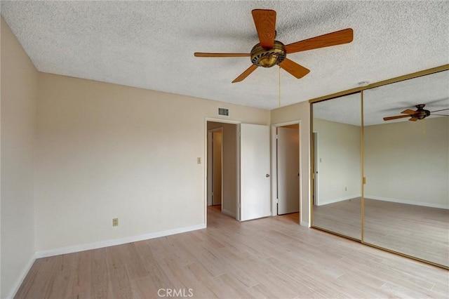 11000 Woodruff Ave Unit 14, Downey, CA 90241 - unfurnished bedroom featuring a textured ceiling, light wood-type flooring, baseboards, ceiling fan, and a closet