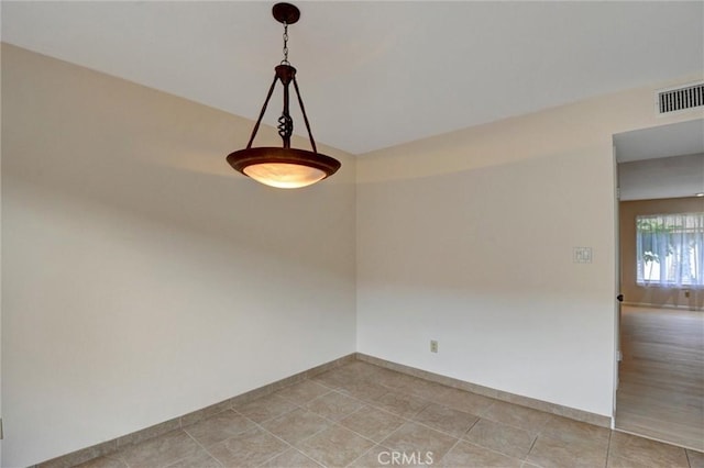 11000 Woodruff Ave Unit 14, Downey, CA 90241 - empty room with light tile patterned floors and baseboards