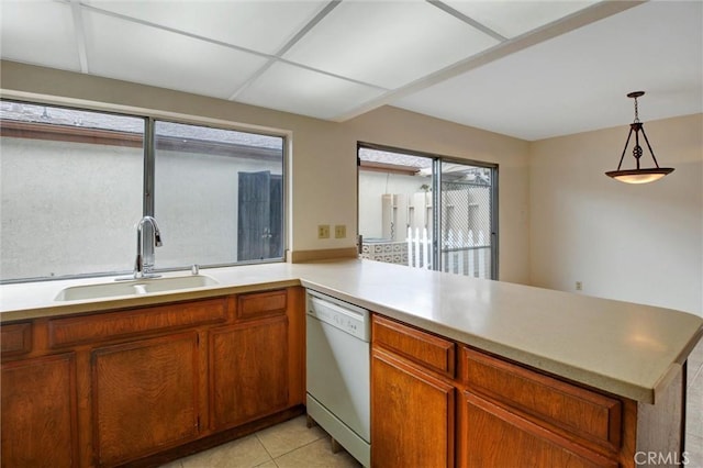 11000 Woodruff Ave Unit 14, Downey, CA 90241 - kitchen featuring a sink, white dishwasher, a peninsula, light countertops, and hanging light fixtures