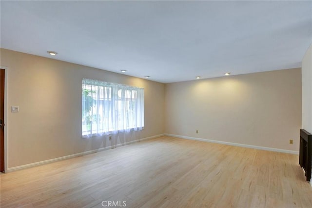 11000 Woodruff Ave Unit 14, Downey, CA 90241 - unfurnished room featuring light wood-style floors, baseboards, and recessed lighting
