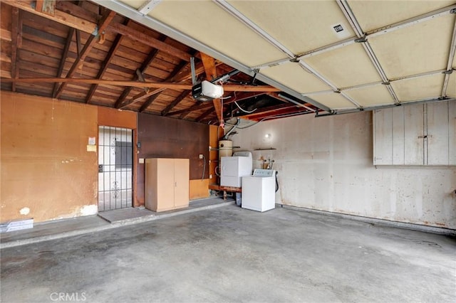 11000 Woodruff Ave Unit 14, Downey, CA 90241 - garage featuring a garage door opener, washer / dryer, and a central vacuum unit