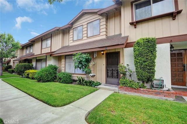 11000 Woodruff Ave Unit 14, Downey, CA 90241 - townhome / multi-family property with board and batten siding and a front yard