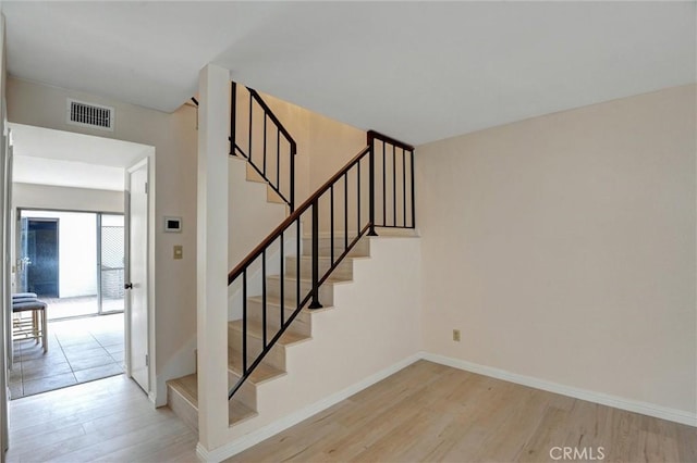 11000 Woodruff Ave Unit 14, Downey, CA 90241 - staircase featuring wood finished floors and baseboards