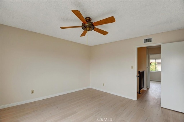 11000 Woodruff Ave Unit 14, Downey, CA 90241 - empty room featuring light wood-style flooring, ceiling fan, a textured ceiling, and baseboards