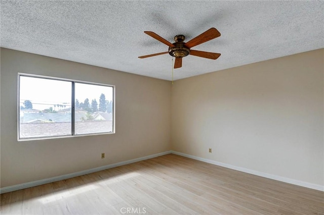 11000 Woodruff Ave Unit 14, Downey, CA 90241 - empty room featuring light wood-style floors, ceiling fan, baseboards, and a textured ceiling
