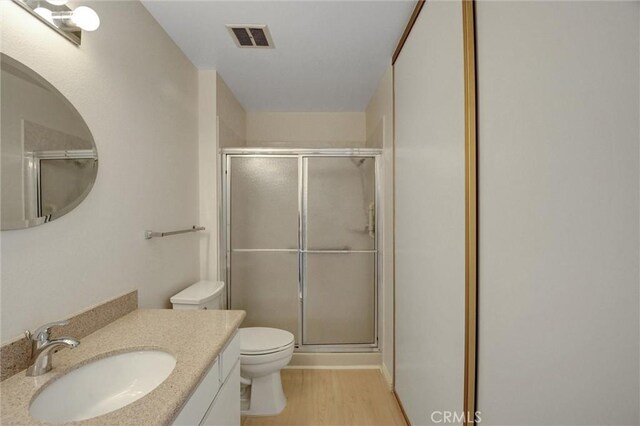 11000 Woodruff Ave Unit 14, Downey, CA 90241 - bathroom with toilet, a shower stall, wood finished floors, and vanity