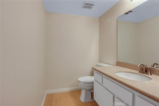 11000 Woodruff Ave Unit 14, Downey, CA 90241 - half bathroom with toilet, wood finished floors, vanity, and baseboards