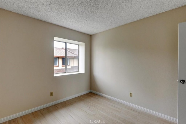 11000 Woodruff Ave Unit 14, Downey, CA 90241 - empty room featuring light wood-type flooring, baseboards, and a textured ceiling