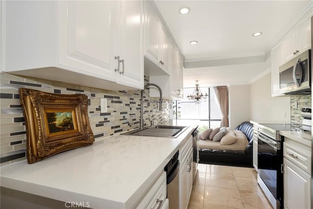 321 N Oakhurst Dr Unit 404, Beverly Hills, CA 90210 - kitchen featuring stainless steel appliances, a sink, white cabinetry, backsplash, and recessed lighting