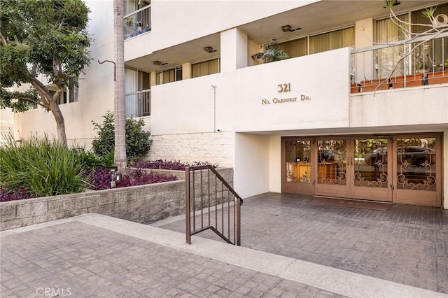321 N Oakhurst Dr Unit 404, Beverly Hills, CA 90210 - view of exterior entry with stucco siding and french doors