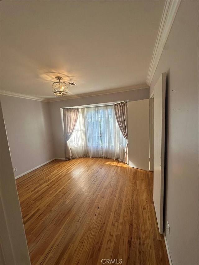 7918 Kyle St, Sunland, CA 91040 - unfurnished room with crown molding, wood finished floors, and baseboards